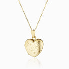 Child's 9 ct gold heart locket engraved with stars, a wand and the word Wishes on a 9 ct gold belcher chain.