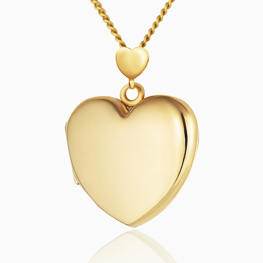 9 ct gold heart locket with a heart shaped bail, on a 9 ct gold curb chain