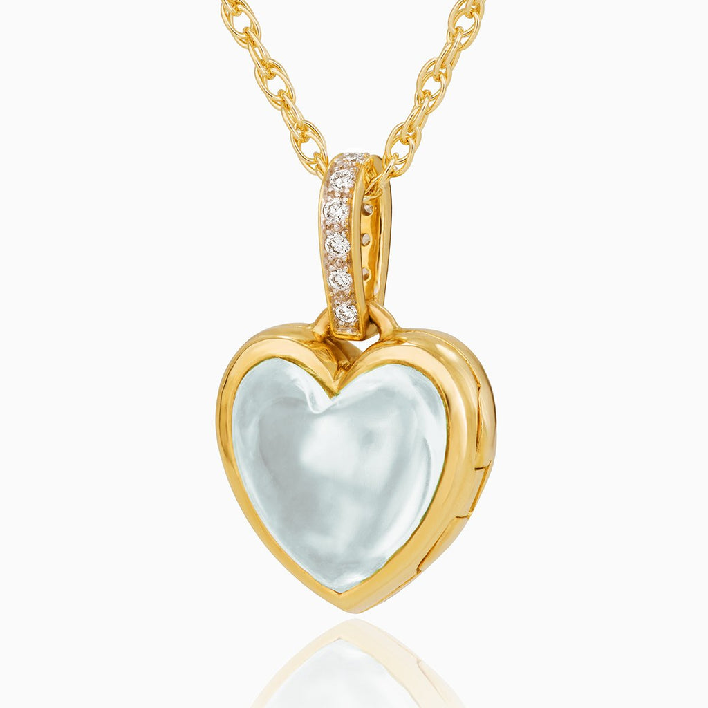 Petite reversible 18 ct gold heart locket set with aquamarine one one side and diamonds on the other side, on an 18 ct gold chain