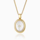 18 ct gold oval locket set with mother of pearl and a central diamiond, on an 18 ct gold franco chain