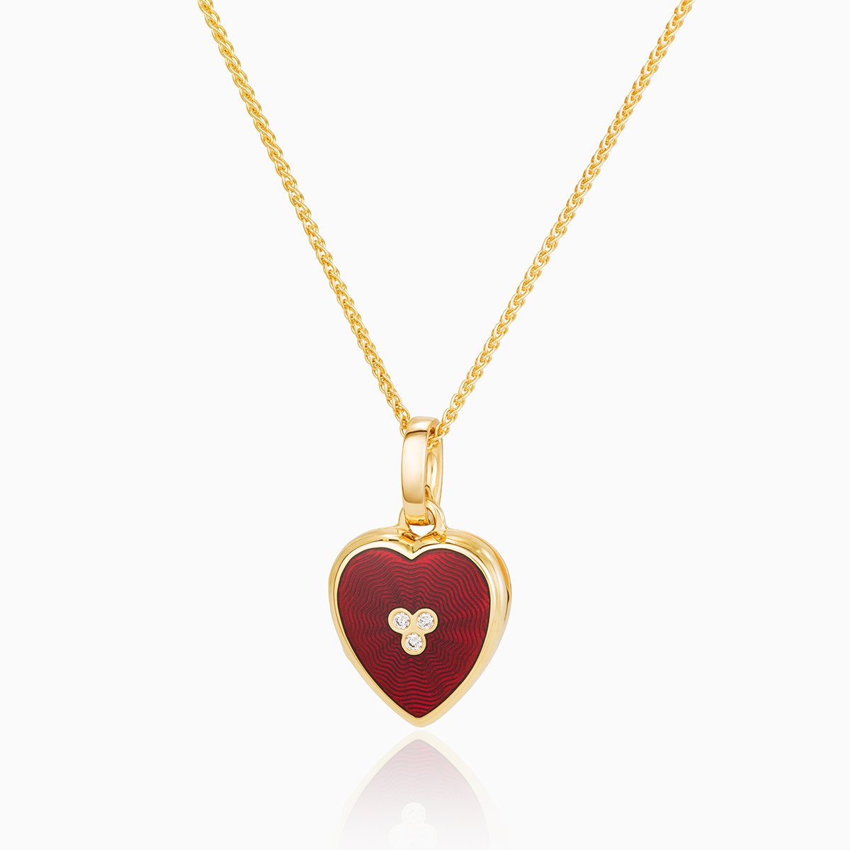 18 ct gold heart locket set with red guilloche enamel and 3 central diamonds on an 18 gold spiga chain