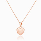 Front shot of a petite 9 ct rose gold heart locket on a 9 ct rose gold curb chain.