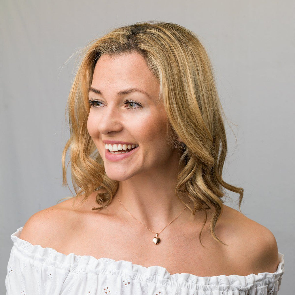 Model wearing a petite 9 ct rose gold heart locket on a 9 ct rose gold curb chain.