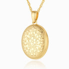 9 ct gold oval locket with floral hand engraved design on 9 ct gold rope chain