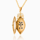 Open view of an elongated 9 ct gold locket set with sapphires on a 9 ct gold rope chain