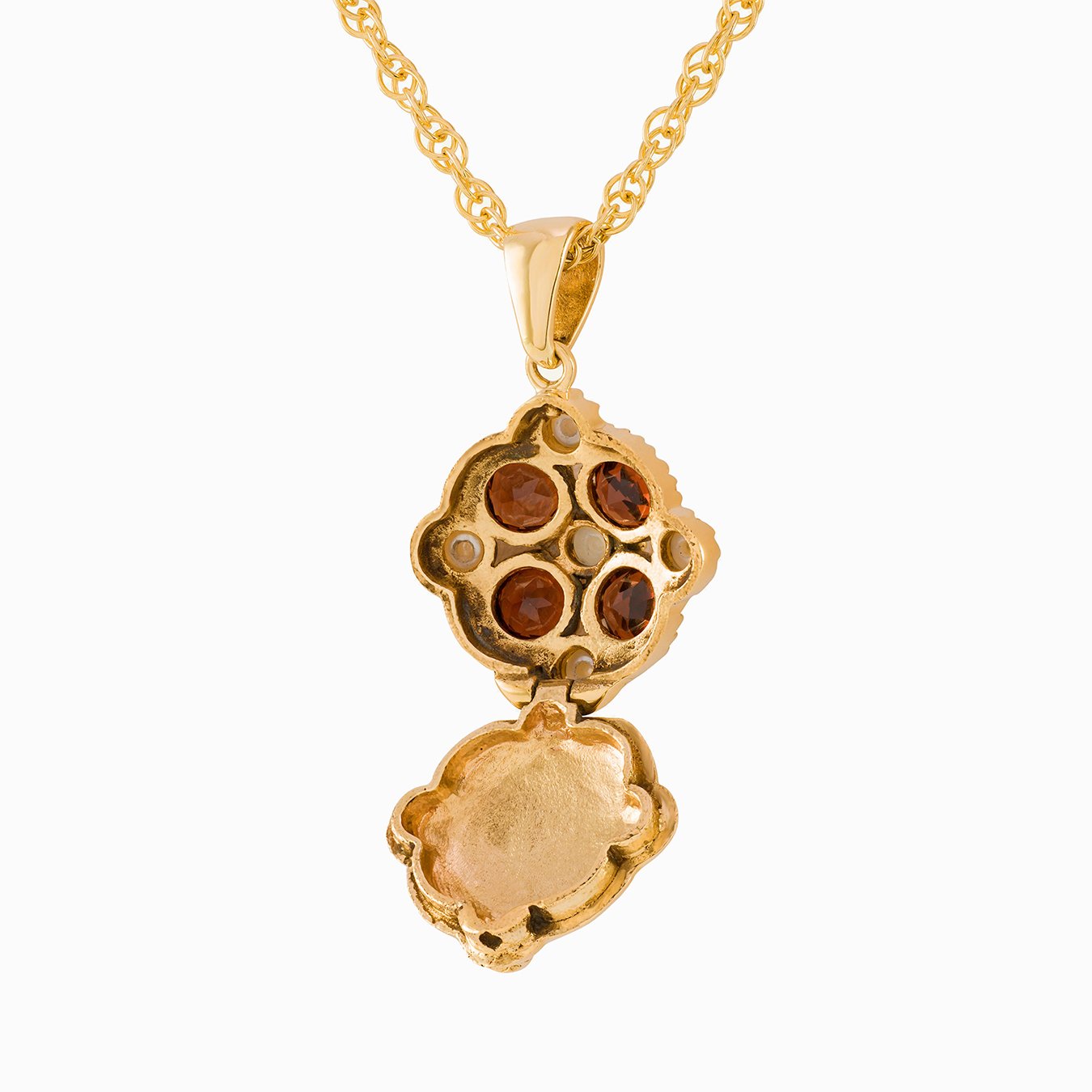 Open view of a 9 ct gold tipped square locket set with garnets and seed pearls, on a 9 ct rope chain