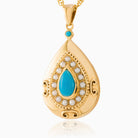 9 ct gold teardrop shaped locket set with a turquoise cabochon surrounded by seed pearls, on a 9 ct gold rope chain