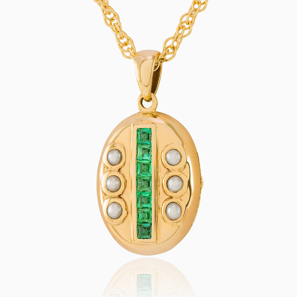 Petite 9 ct gold oval locket set with emeralds and seed pearls on a 9 ct gold rope chain.