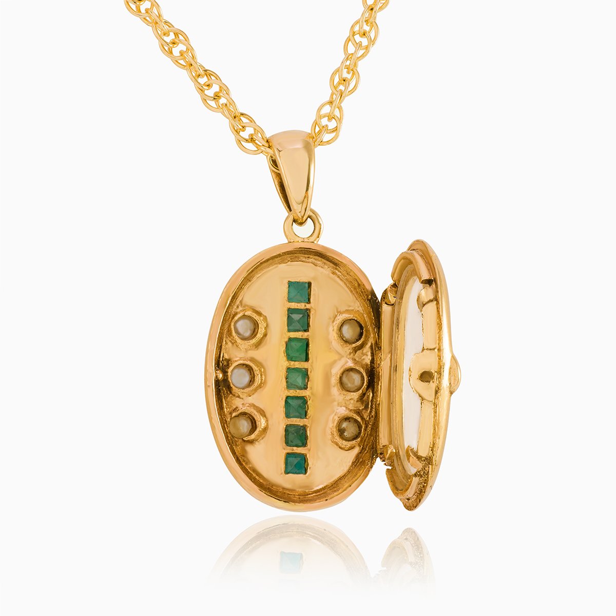 Open view of a petite 9 ct gold oval locket set with emeralds and seed pearls on a 9 ct gold rope chain.