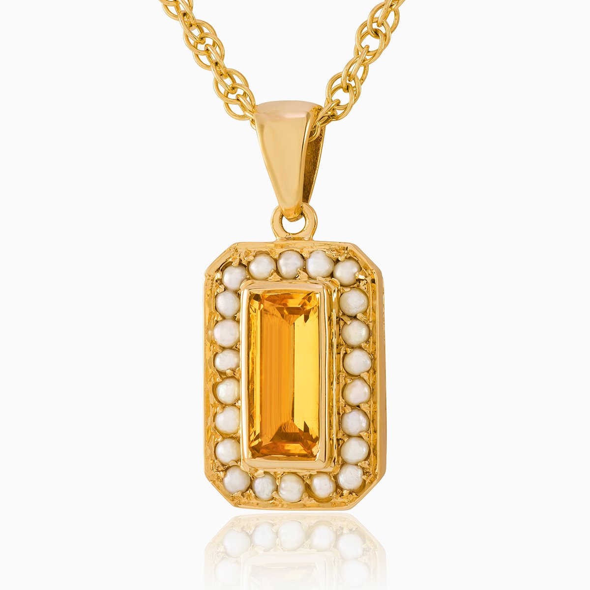 9 ct gold tabular shaped locket set with a citrine and seed pearls ona 9 ct gold rope chain