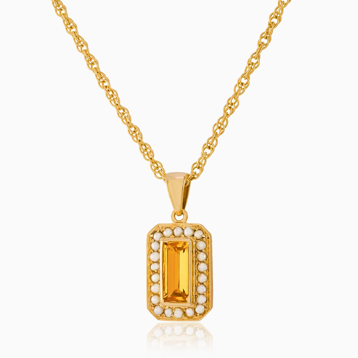 9 ct gold tabular shaped locket set with a citrine and seed pearls ona 9 ct gold rope chain