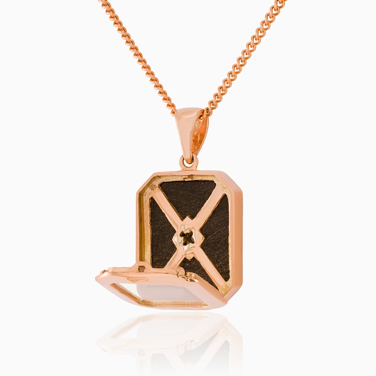 Open view of a glass backed 9 ct rose gold tabular shaped locket on a 9 ct rose gold curb chain