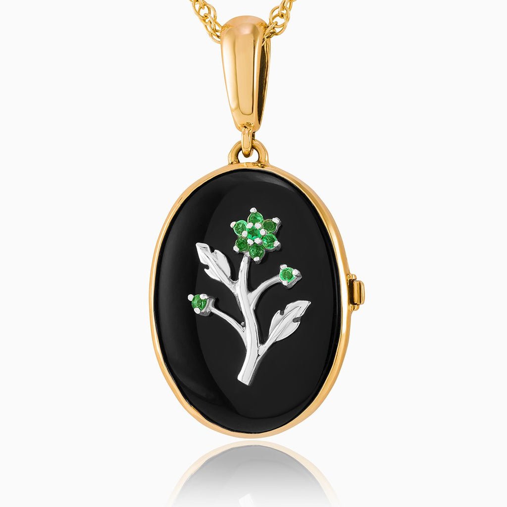 9 ct gold oval locket set with diamonds and a white gold floral design on an onyx background, on a 9 ct gold rope chain