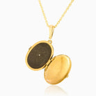 Open view of a 9 ct gold oval locket set with onyx on a 9 ct gold rope chain