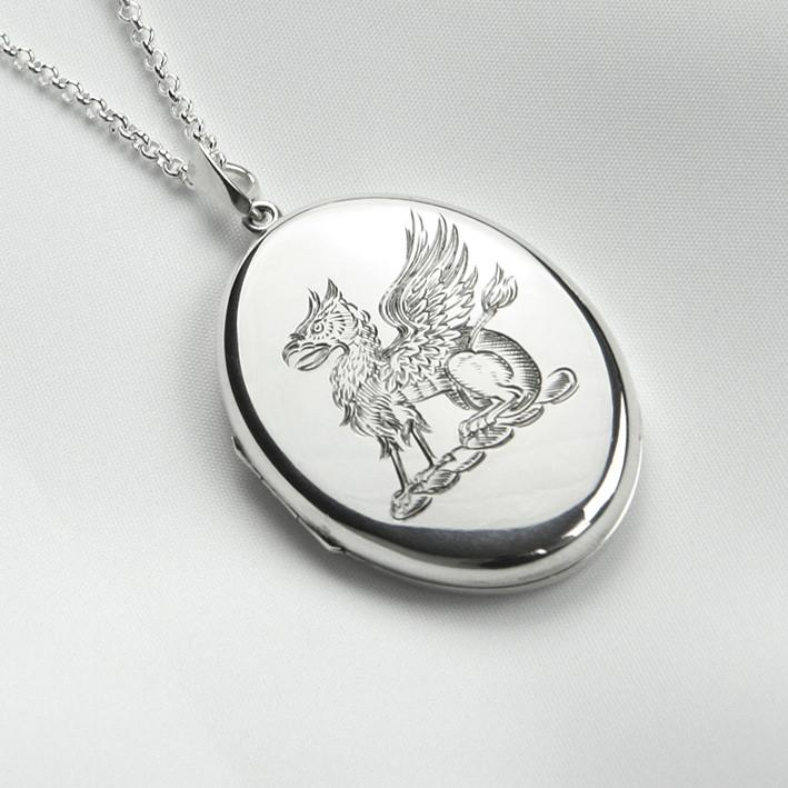 Large sterling silver oval locket with hand engraved Gryphon design.