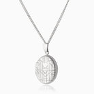This is a front shot of a 925 sterling silver oval locket, hand engraved with an art deco chevron design on the front.