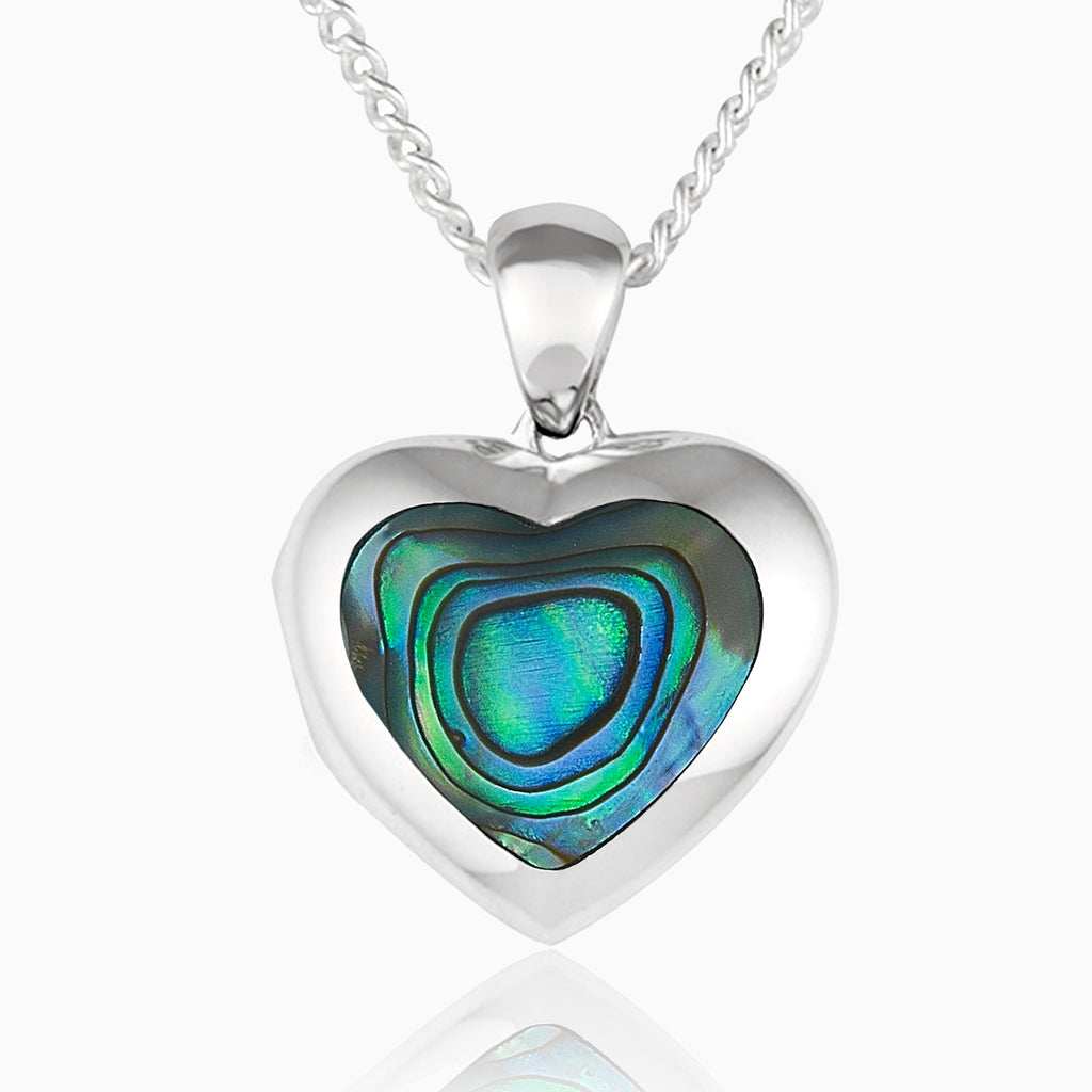 Front shot of a petite heart-shaped sterling silver locket set with abalone shell on a sterling silver curb chain.