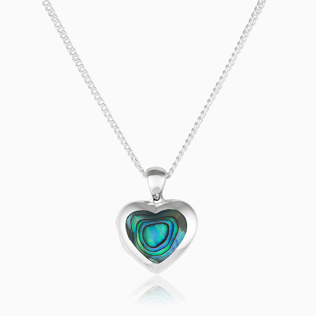 Front shot of a petite heart-shaped sterling silver locket set with abalone shell on a sterling silver curb chain.