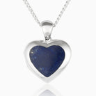 Front shot of a petite heart-shaped sterling silver locket set with lapis lazuli on a sterling silver curb chain.