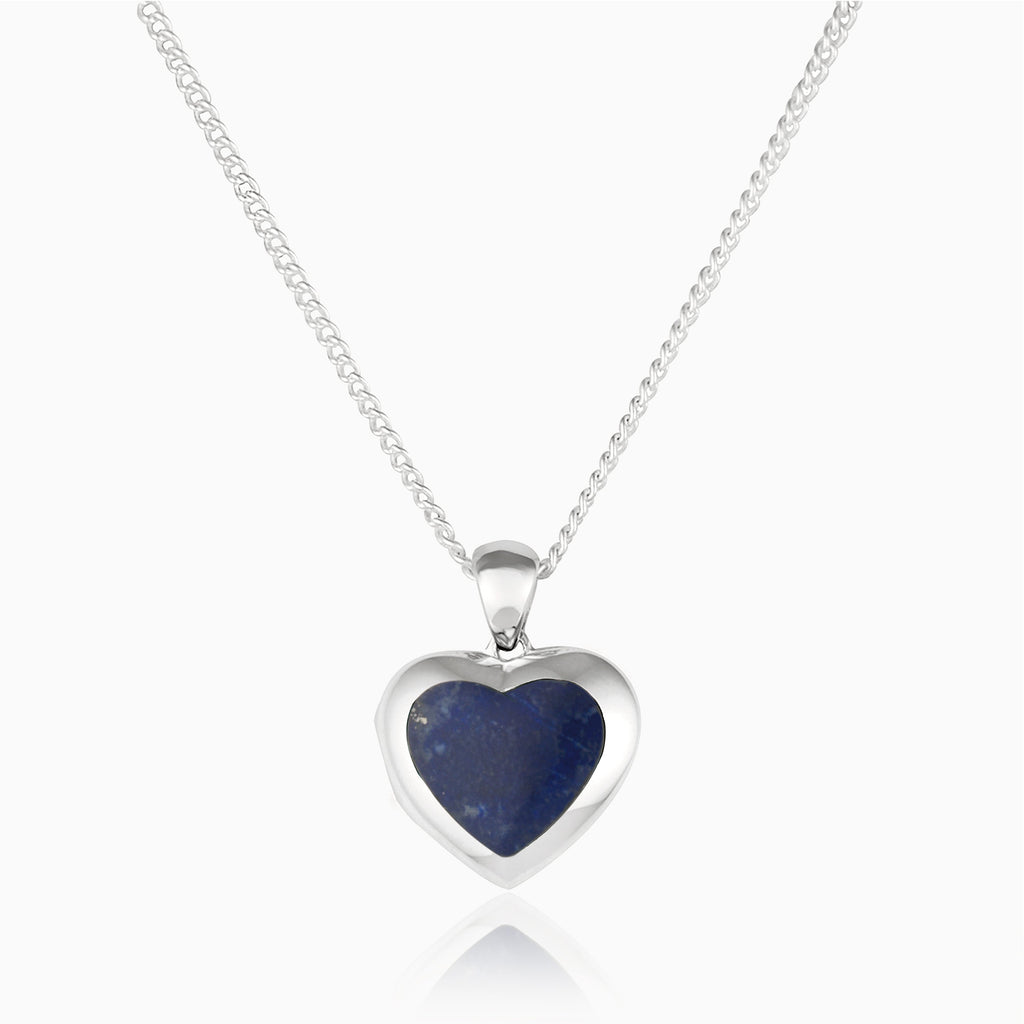 Front shot of a petite heart-shaped sterling silver locket set with lapis lazuli on a sterling silver curb chain.