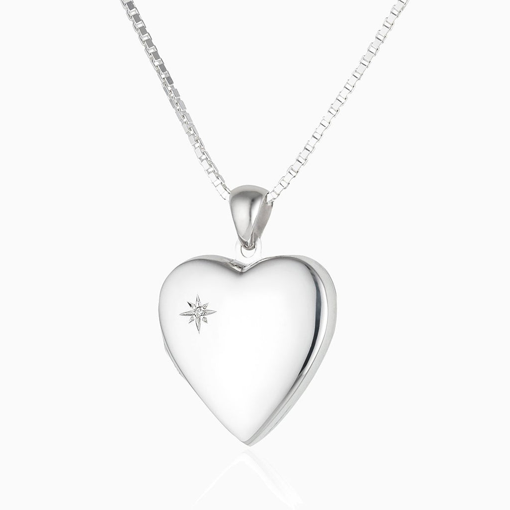 sterling silver heart locket set with a diamond in the top left corner, on a sterling silver curb chain
