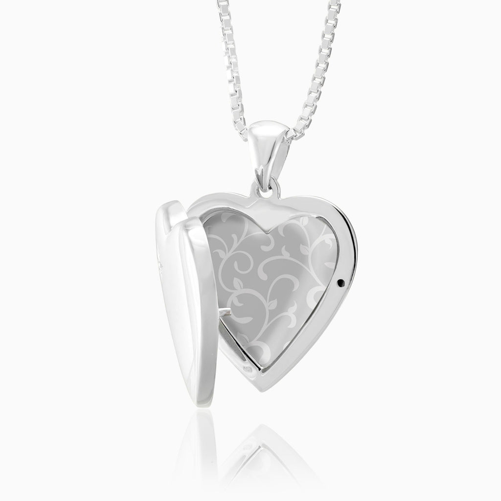 open view of a sterling silver heart locket set with a diamond in the top left corner, on a sterling silver box chain