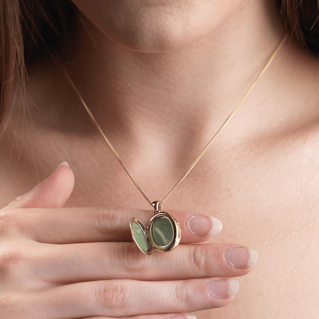 Model showing an open 9 ct gold 4-photo locket on a 9 ct gold curb chain