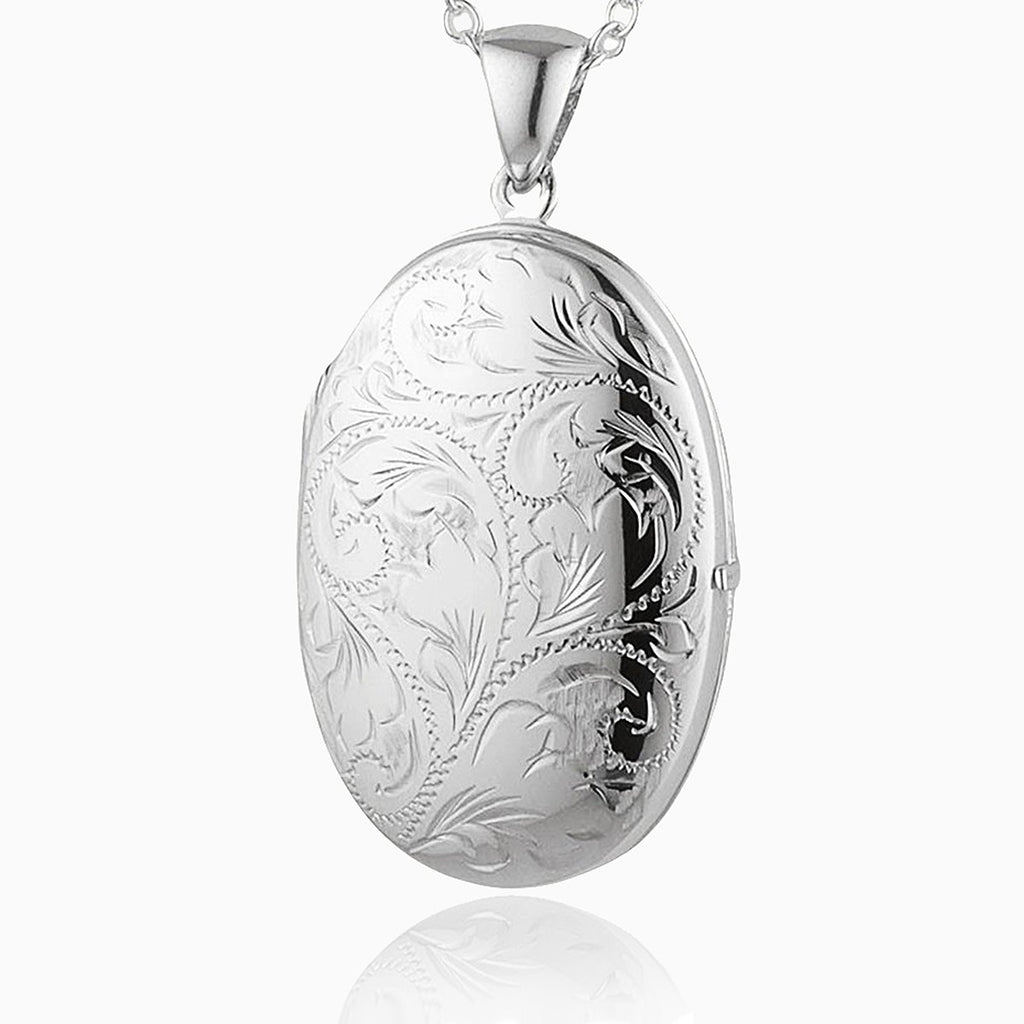 Large Victorian style locket, engraved with a traditional foliate design.