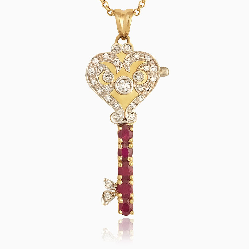 18 ct gold locket in the shape of a key set with diamonds and rubies, on an 18 ct gold trace chain