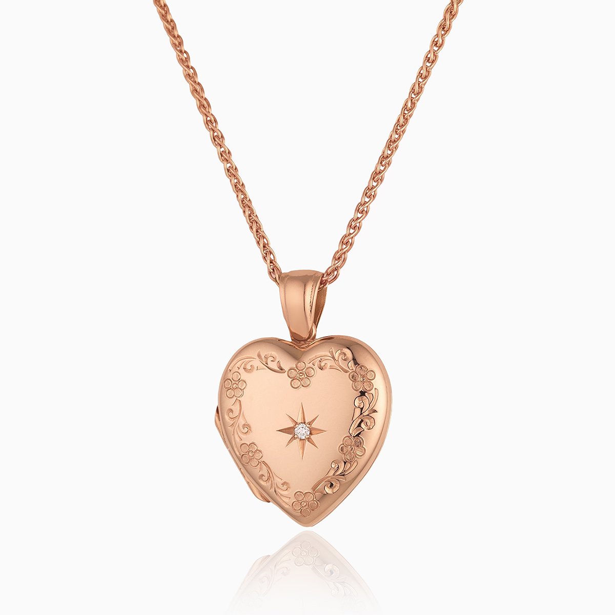 18 ct rose gold heart locket engraved with a floral border and star set with a diamond, on an 18 ct rose gold spiga chain