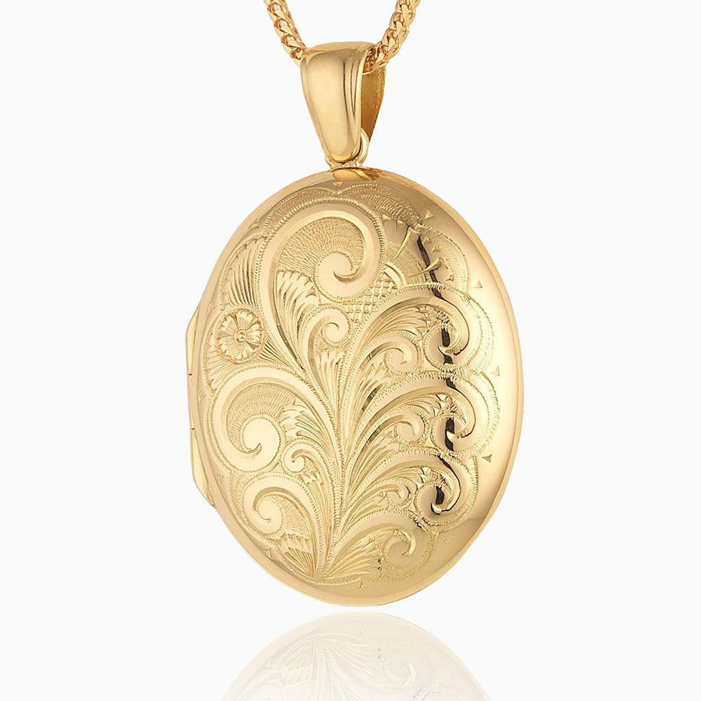 Large oval 18 ct gold locket engraved with a foliate design, on an 18 ct gold franco chain