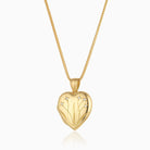 18 ct gold heart locket set with diamonds and engraved with a floral design, on an 18 ct gold franco chain