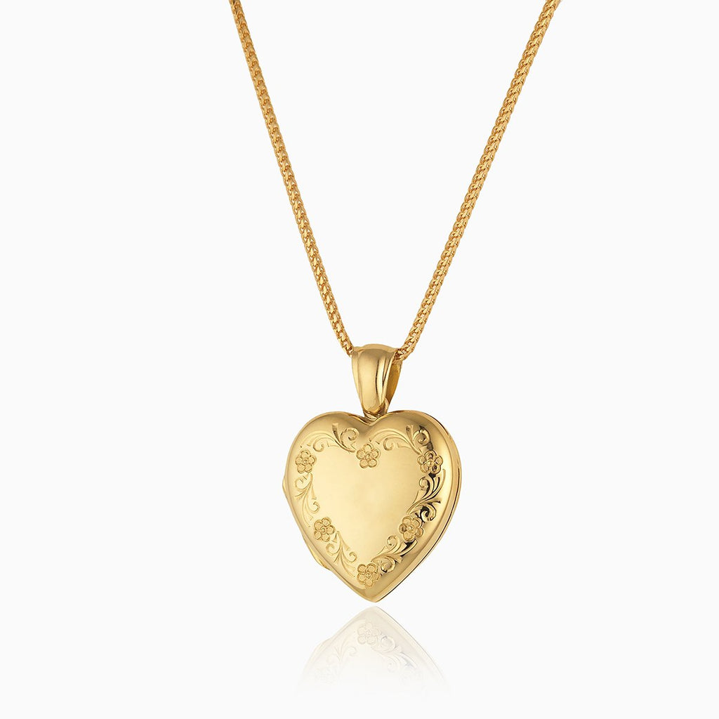 18 ct gold heart locket engraved with a floral border on an 18 ct gold franco chain