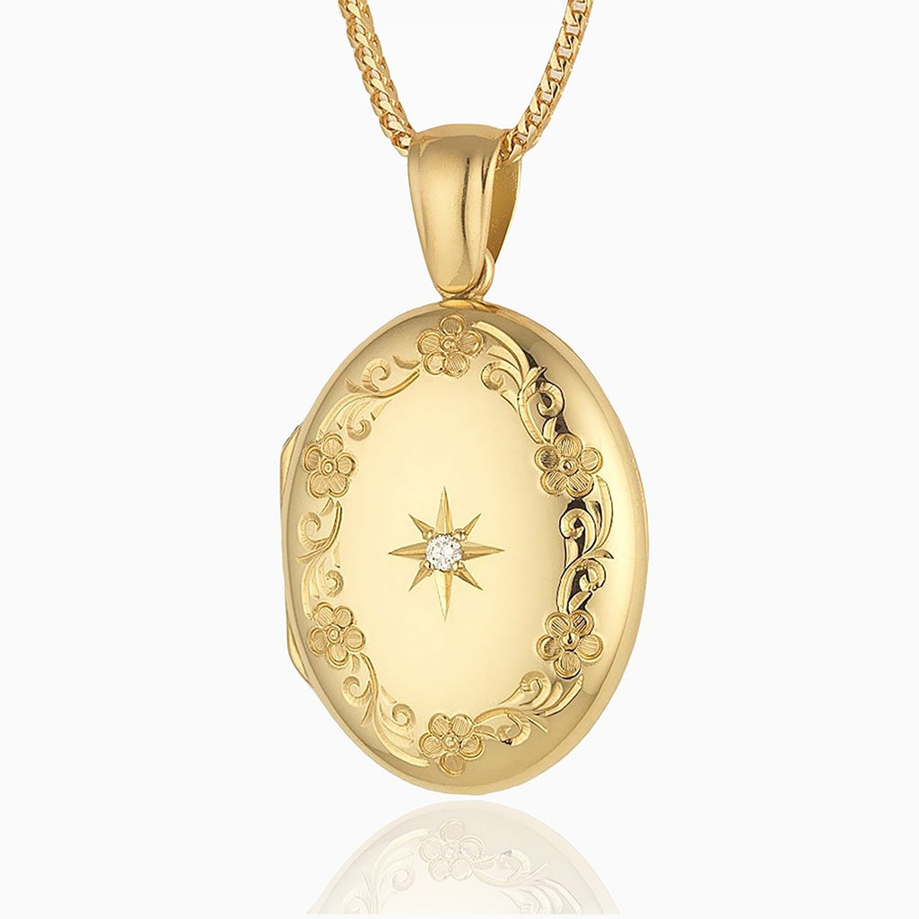 18 ct gold oval locket engraved with a floral border and star set with a central diamond, on an 18 ct gold franco chain.
