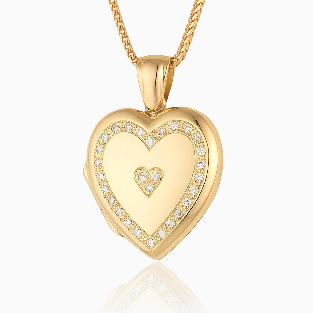 18 ct gold heart locket set with diamonds around the rim and 3 diamonds in the middle in a heart shape, on an 18 ct gold franco chain