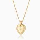 18 ct gold heart locket set with diamonds around the rim and 3 diamonds in the middle in a heart shape, on an 18 ct gold franco chain