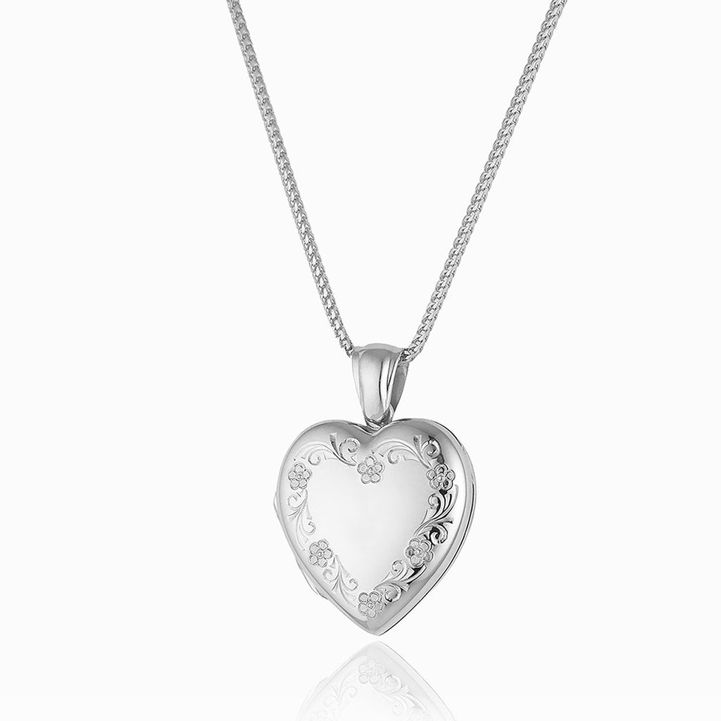 18 ct white gold heart locket engraved with a floral border, on an 18 ct white gold chain