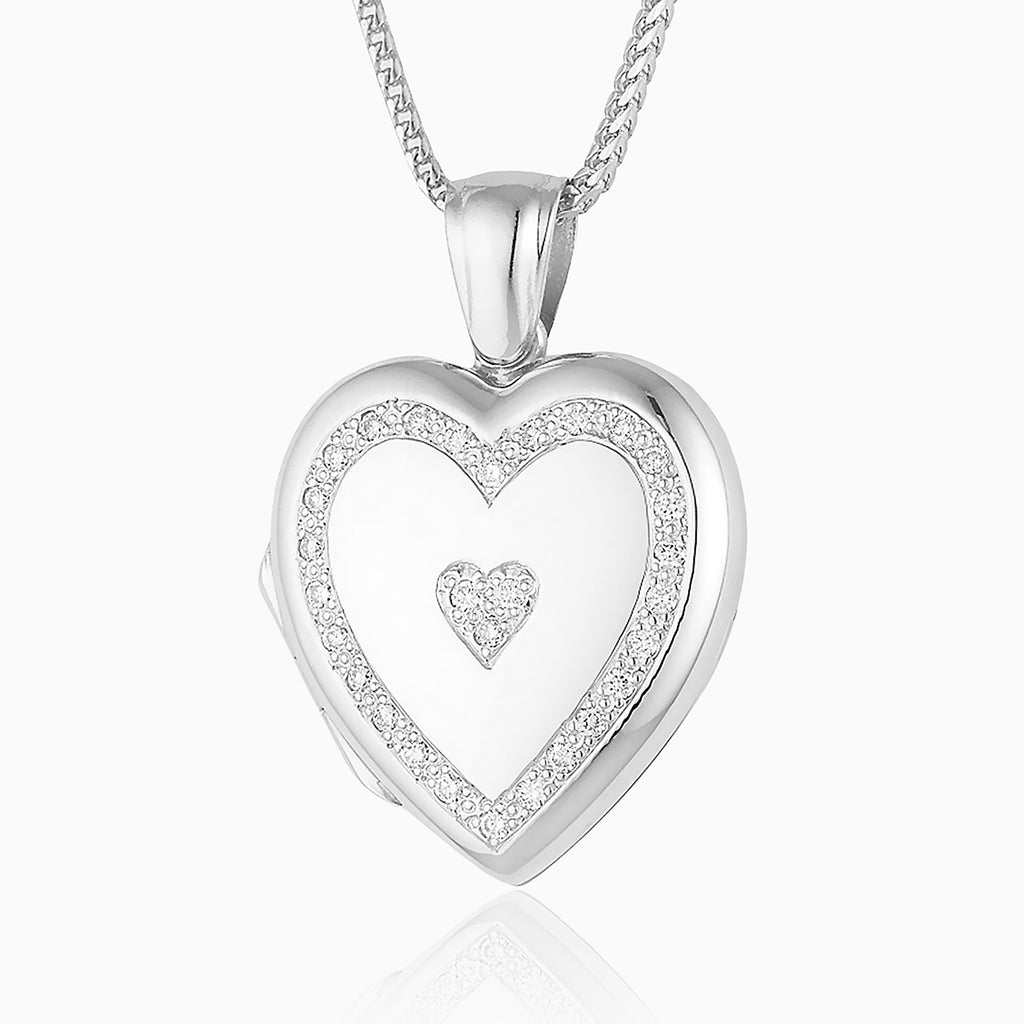An 18 ct white gold heart shaped locket set with diamonds in a heart border. With an 18ct white gold chain