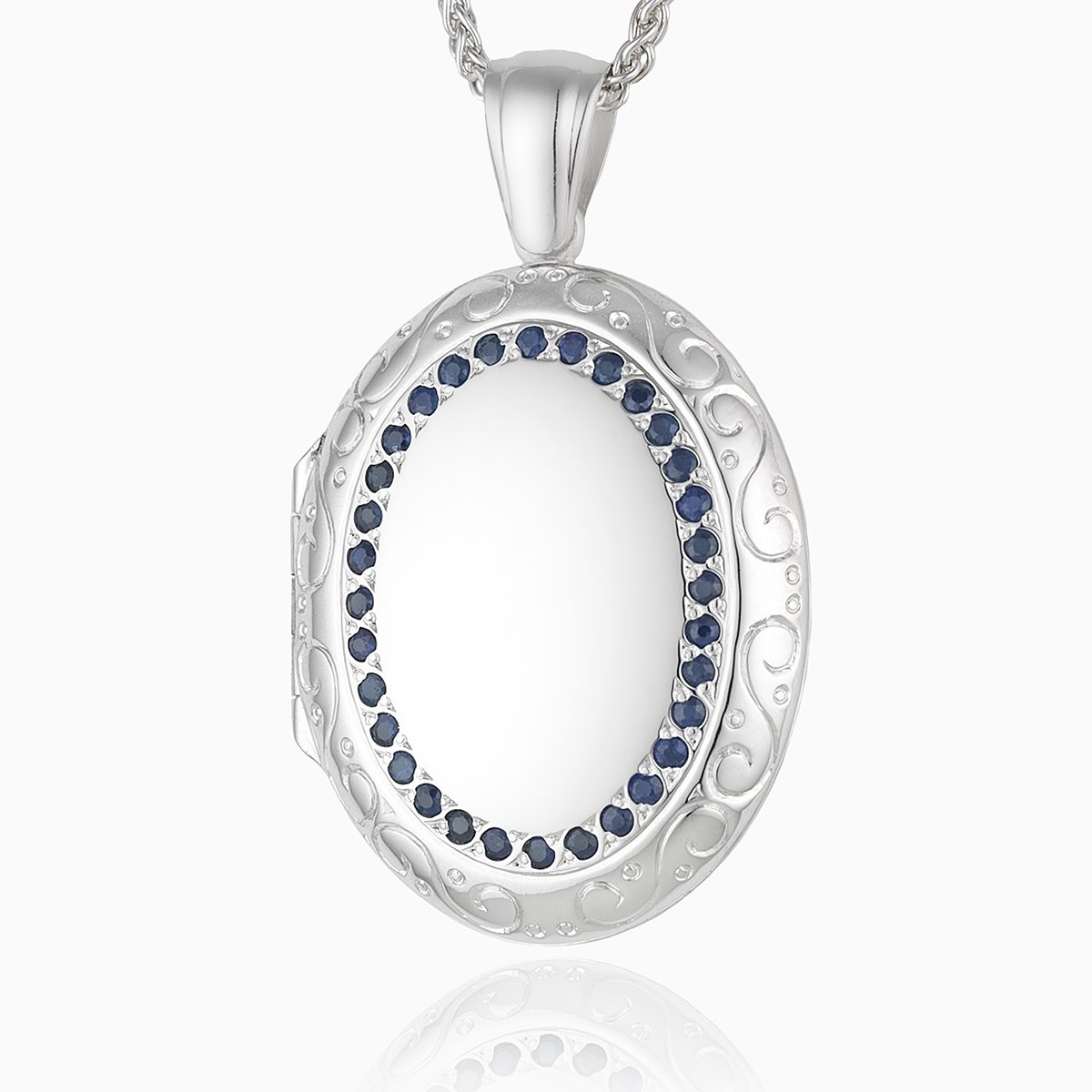 18 ct white gold large oval 4-photo locket set with blue sapphires and an engraved border, on an 18 ct white gold spiga chain
