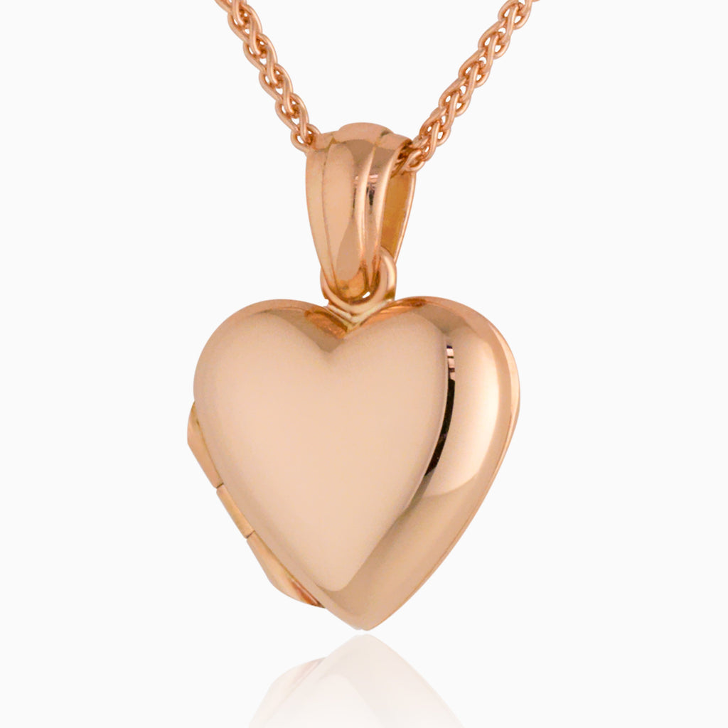 An 18 ct rose gold heart shaped locket  hanging on an 18 ct  rose gold spiga chain.