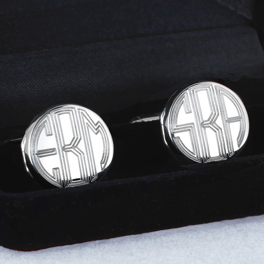 Sterling silver round cufflink lockets showing a monogram engraving, in a black gift box