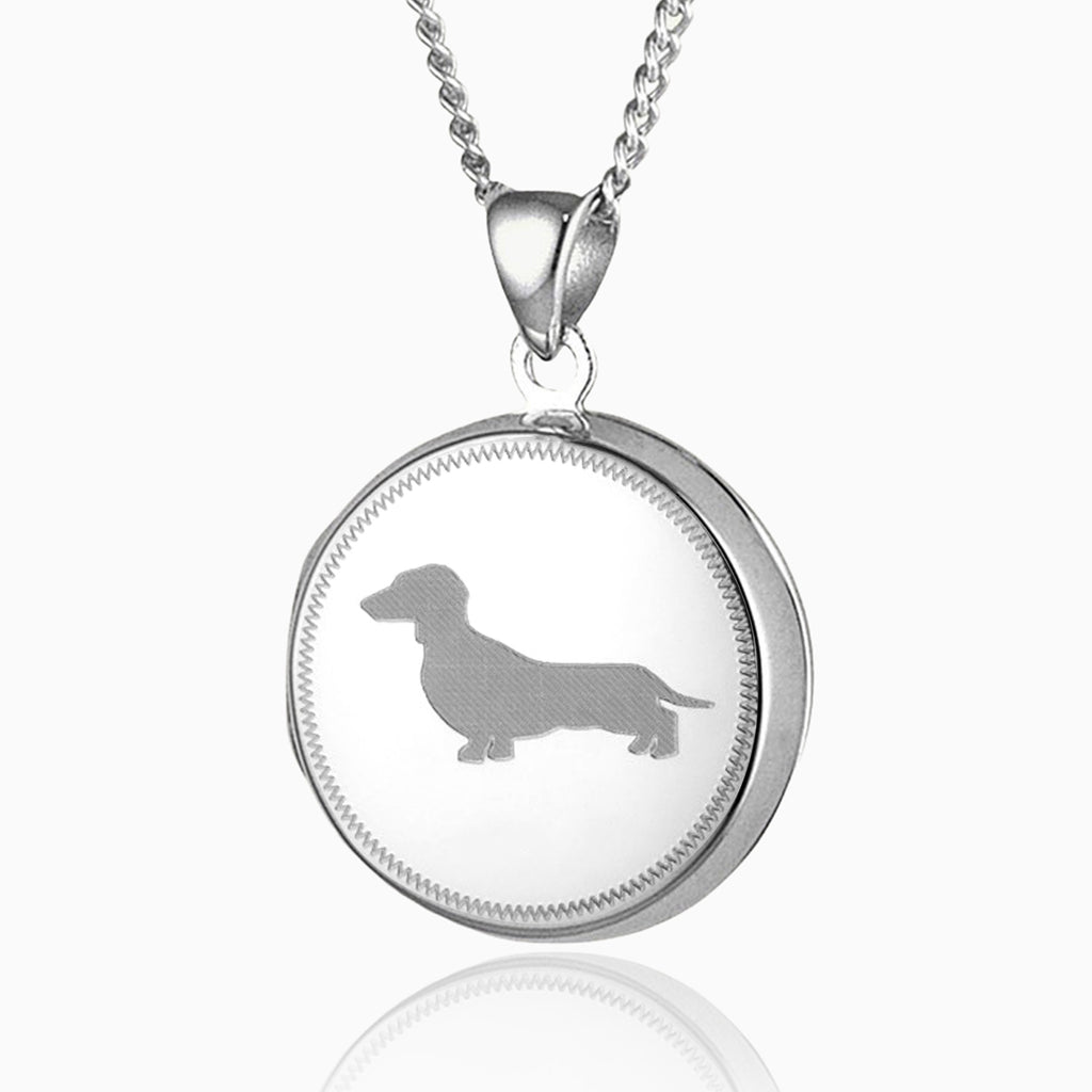 sterling silver round locket with a dachsund engraved on the front