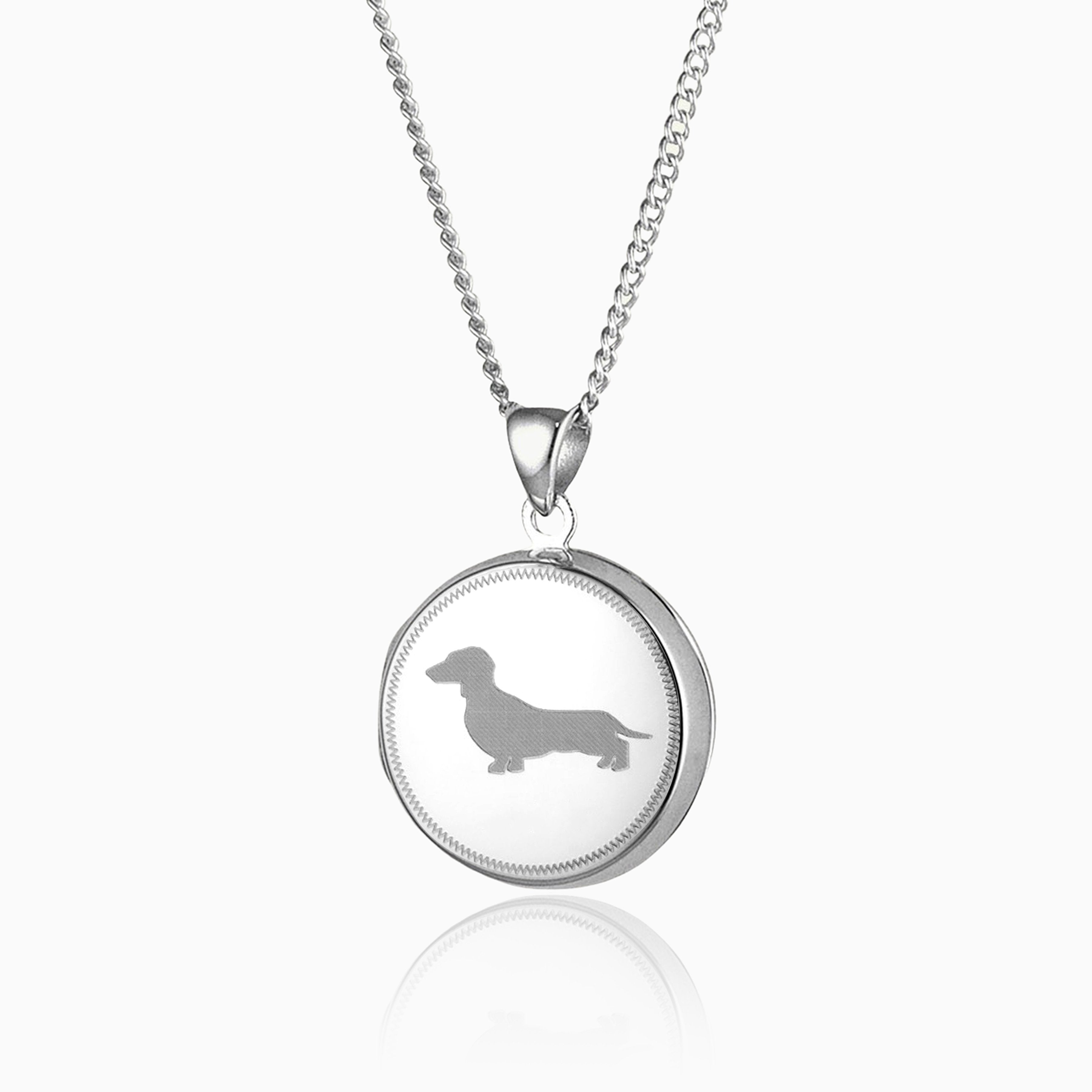 sterling silver round locket with a dachsund engraved on the front
