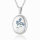 sterling silver oval locket painted with a forget-me-not flower on the front, on a sterling silver rope chain