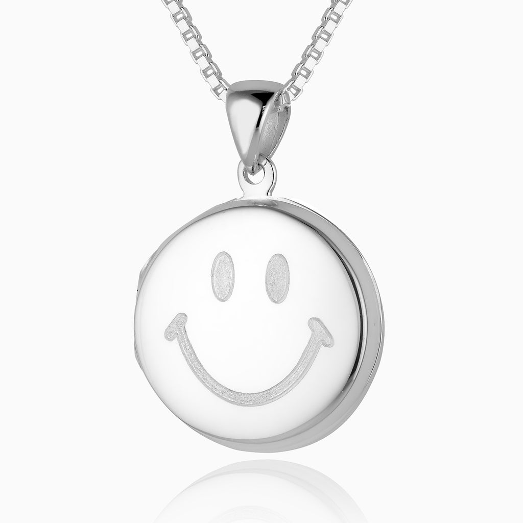 sterling silver round locket with a smiley emoji engraved on the front