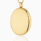 A large oval 9 ct gold 4-photo polished locket on a 9 ct gold belcher chain