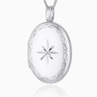 Large oval 9 ct white gold locket star set with a diamond and with an engraved border, on a 9 ct white gold curb chain