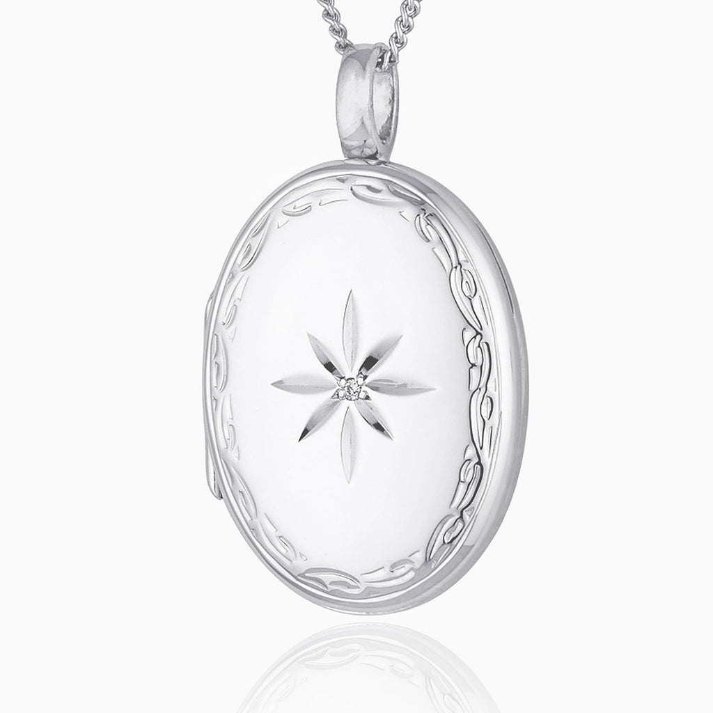 Large oval 9 ct white gold locket star set with a diamond and with an engraved border, on a 9 ct white gold curb chain