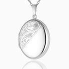 sterling silver oval locket with an engraved foliate design across the left diagonal 