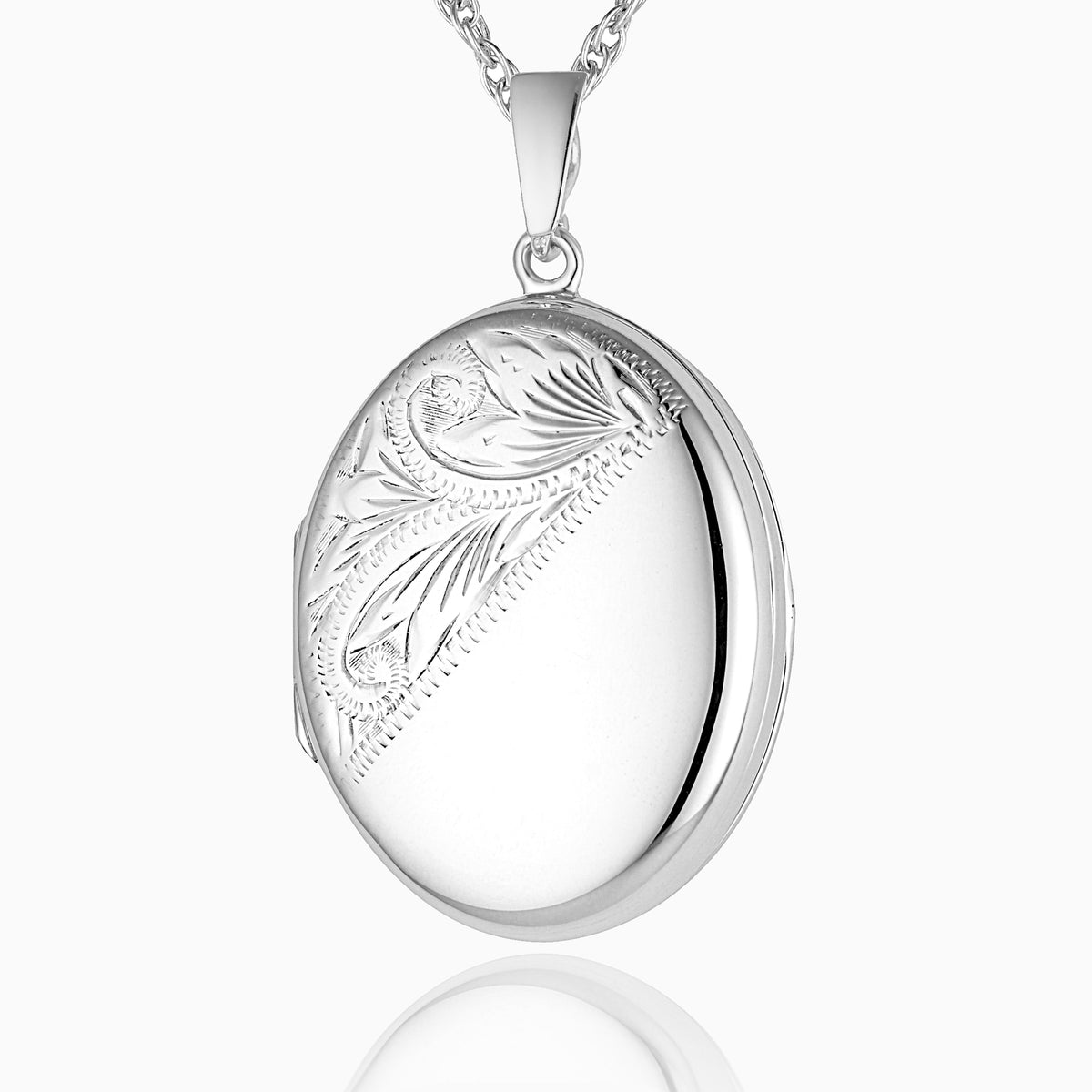 sterling silver oval locket with an engraved foliate design across the left diagonal 